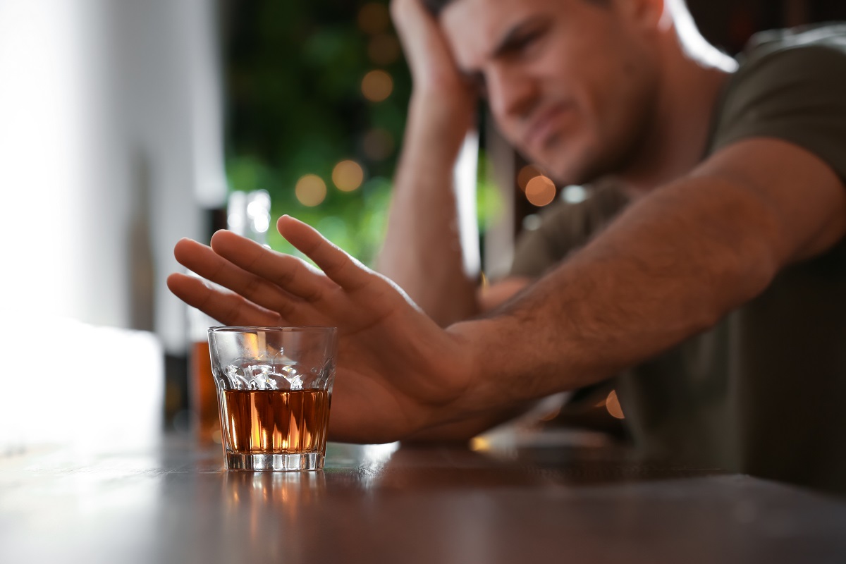 man-refusing-to-drink-alcohol-in-bar-closeup-inspire-change-rehab